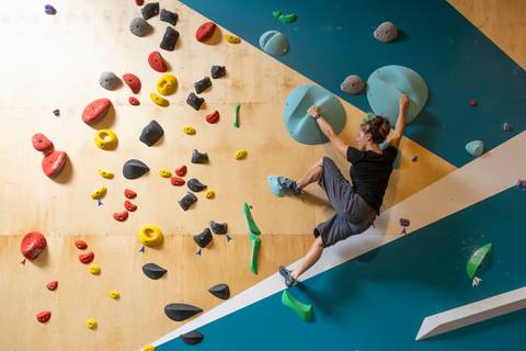 Climber reaching for a hold on an overhang