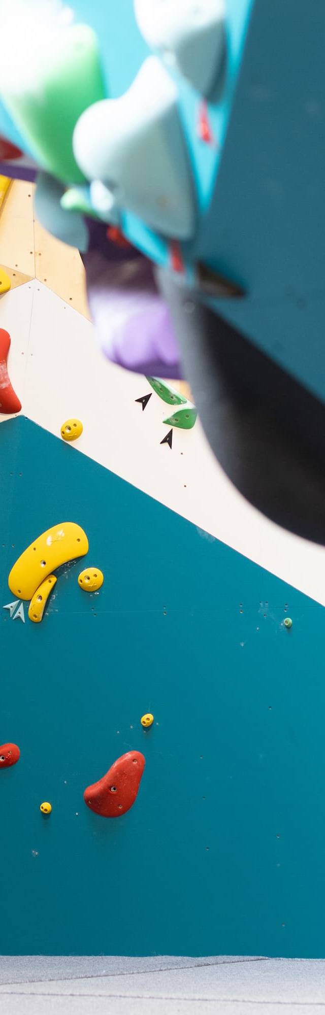 Climbers on the overhang wall at BouldeRryn