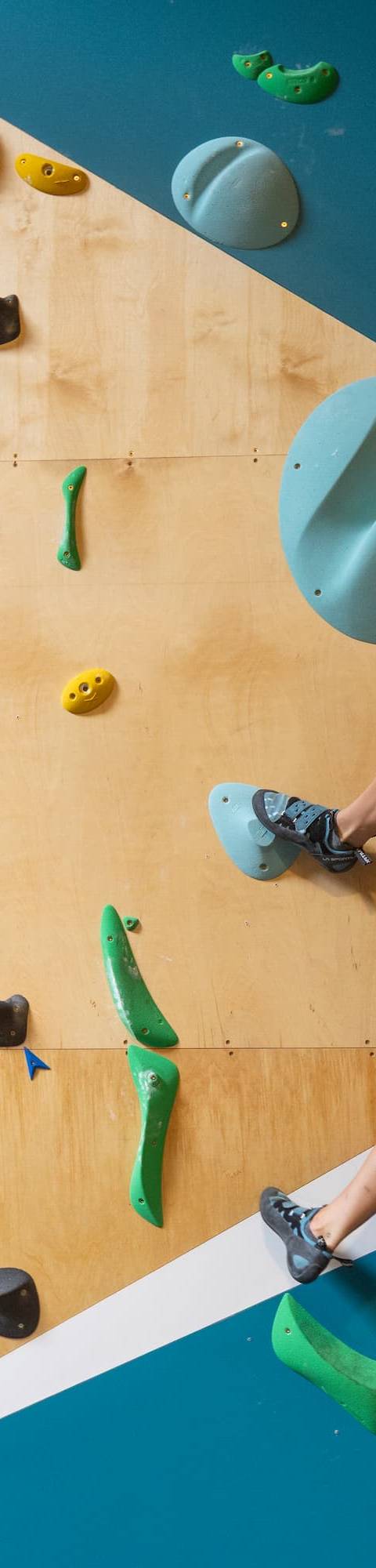 Climber reaching for a hold on an overhang