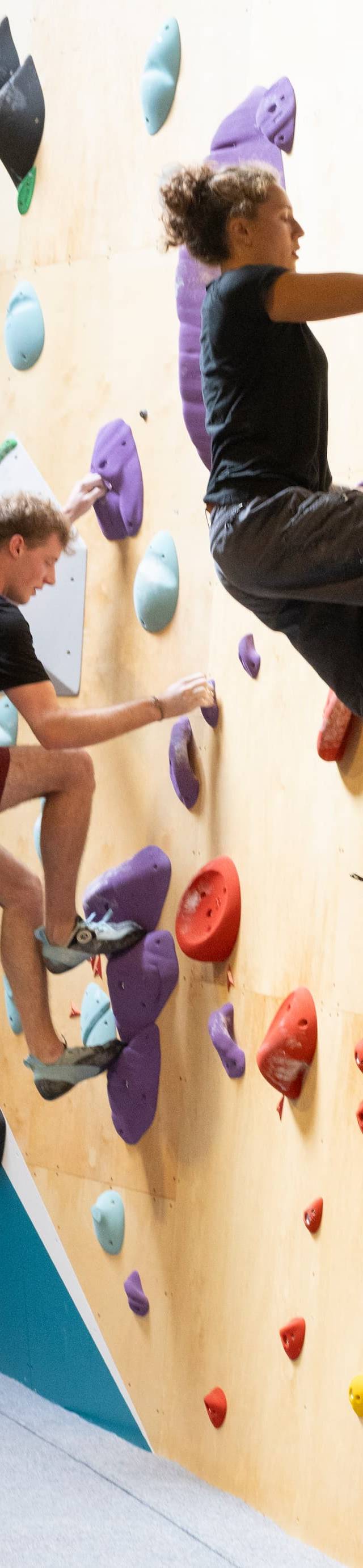 Climber navigating a tall route on the wall